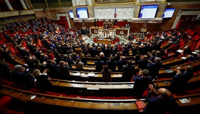 Members of parliament clap as French Prime Minister Elisabeth Borne speaks during a debate on the pension reform plan at the National Assembly in Paris, France February 17, 2023. — Reuters