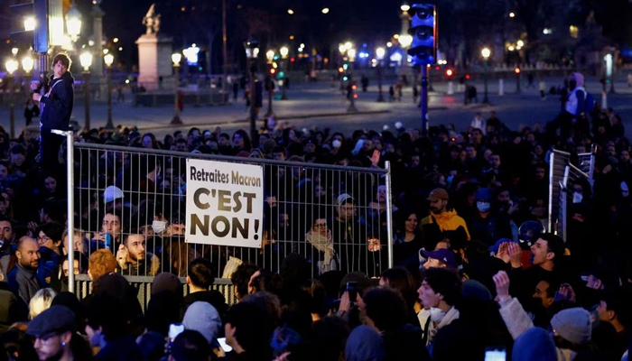 Protesters hold a barricade as they attend a demonstration in front of the National Assembly on Place de la Concorde to protest the use by the French government to push the pensions reform bill through the National Assembly without a vote by lawmakers, in Paris, France on March 17, 2023. — Reuters