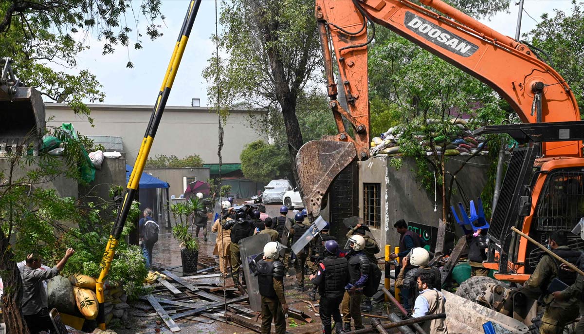 Police personnel use heavy machinery at Imran Khan's residence in Lahore on March 18, 2023.  - AFP