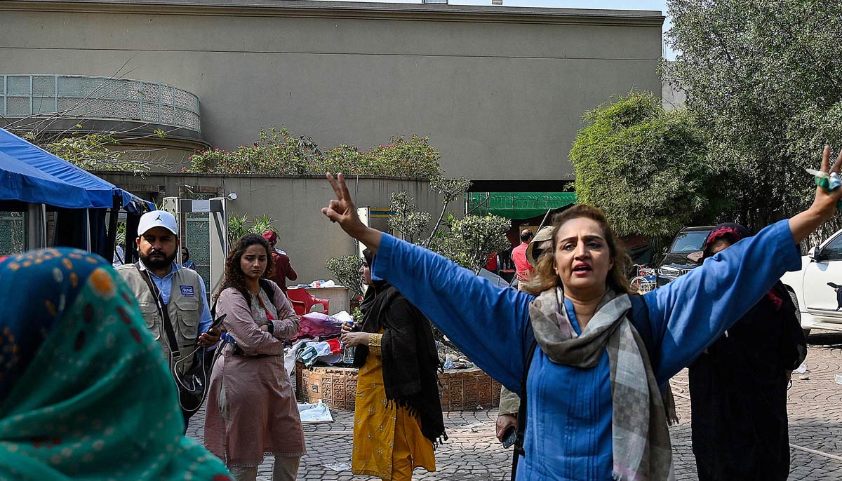 Supporters of Imran Khan gather following a police raid on Khan´s residence in Lahore after Khan left for Islamabad to appear in a court on March 18, 2023. — AFP