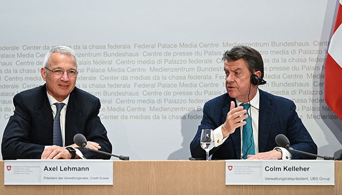 Credit Suisse chairman Axel Lehmann (L) and UBS Chairman Colm Kelleher (R) attend a press conference after talks over UBS taking over its troubled rival Swiss bank Credit Suisse in Bern on March 19, 2023. —AFP