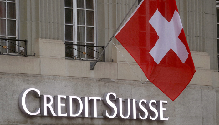 Switzerlands national flag flies above a logo of Swiss bank Credit Suisse in front of a branch office in Bern, Switzerland. — Reuters/File