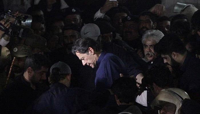 Former prime minister Imran Khan along with his supporters walks as he leaves the Lahore High Court, on February 20, 2023. — Reuters