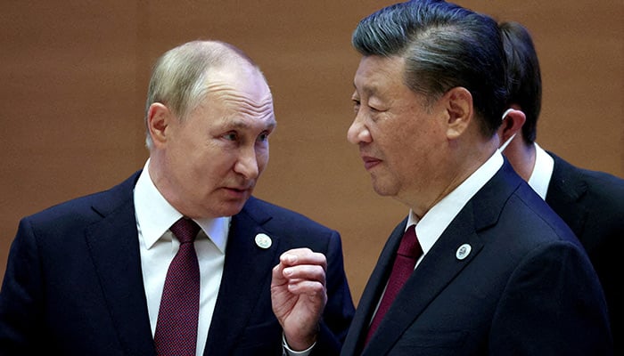 Russian President Vladimir Putin speaks with Chinese President Xi Jinping before an extended-format meeting of heads of the Shanghai Cooperation Organization summit (SCO) member states in Samarkand, Uzbekistan September 16, 2022. — Reuters