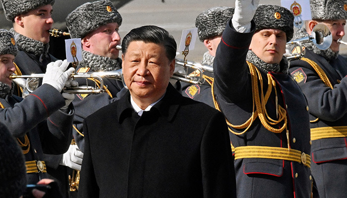 Chinese President Xi Jinping walks past honour guards and members of a military band during a welcoming ceremony upon his arrival at an airport in Moscow, Russia, March 20, 2023. — Reuters