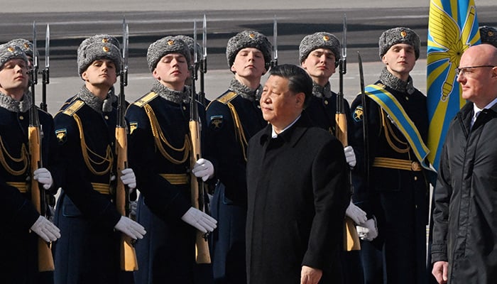 Chinese President Xi Jinping, accompanied by Russian Deputy Prime Minister Dmitry Chernyshenko, walks past honour guards and members of a military band during a welcoming ceremony upon his arrival at an airport in Moscow, Russia, March 20, 2023. — Reuters