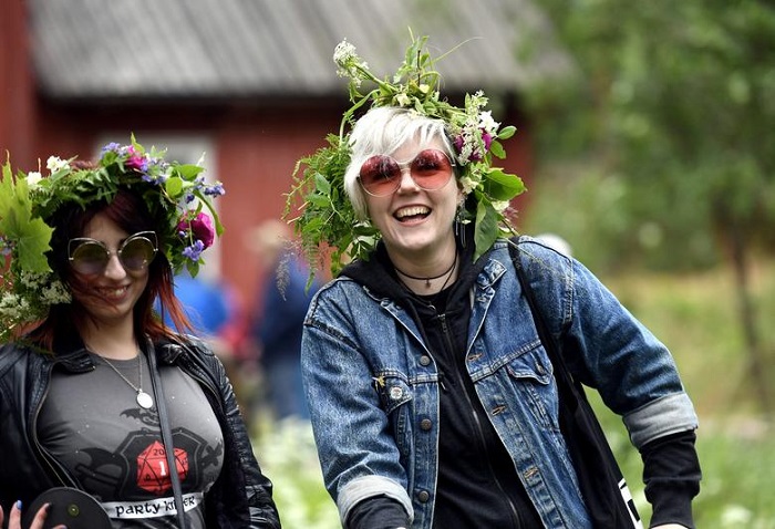 Girls wearing flower garlands celebrate the summer solstice during the Seurasaari open-air museums Midsummer Eve festival in Helsinki, Finland June 22, 2018. — Reuters/File