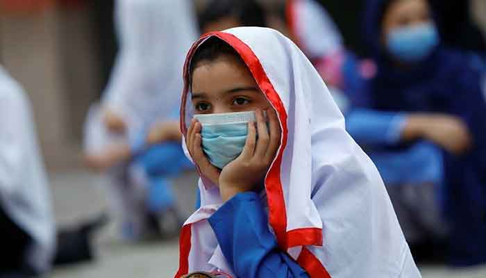 A student wears a protective mask maintaining a safe distance along with others before entering a class after the government allowed reopening of schools in Pakistan. — Reuters