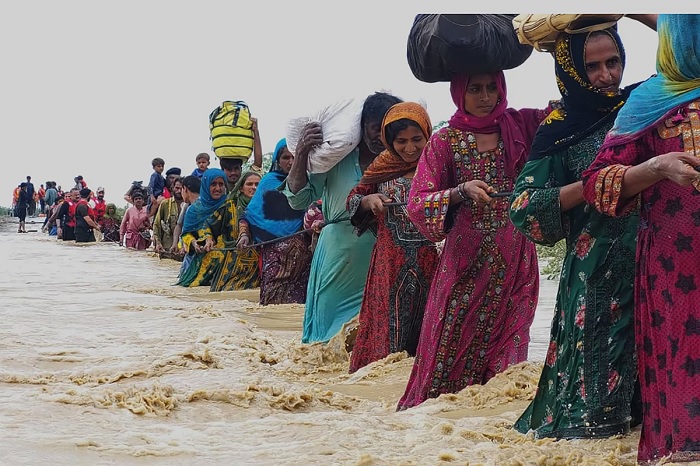 Rescue workers help villagers evacuate from a flooded area after heavy rains fell in Lasbella, a district in Pakistans southwest Balochistan province, on July 26, 2022. — AFP