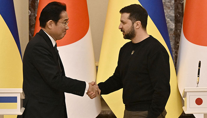 Ukrainian President Volodymyr Zelensky (R) and Japan´s Prime Minister Fumio Kishida (L) shake hands during a joint press conference after their meeting in Kyiv on March 21, 2023, amid the Russian invasion of Ukraine. Japan´s prime minister arrived in Kyiv on March 21, after the foreign ministry announced he was headed on a surprise trip to Ukraine.—AFP
