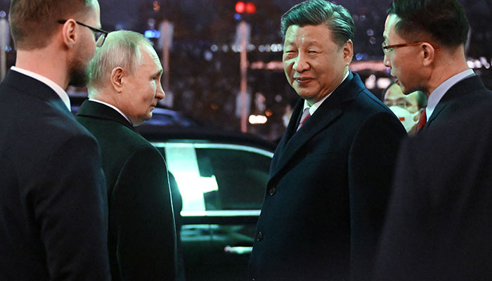 Russian President Vladimir Putin sees off Chinese President Xi Jinping after a reception following their talks at the Kremlin in Moscow on March 21, 2023. AFP
