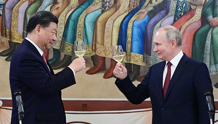 Russian President Vladimir Putin and China´s President Xi Jinping make a toast during a reception following their talks at the Kremlin in Moscow on March 21, 2023. AFP