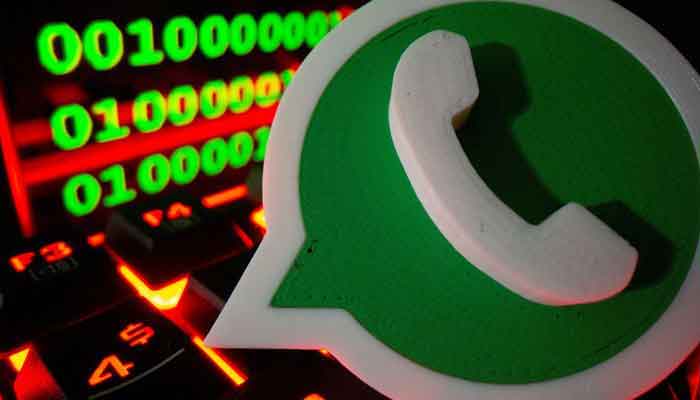 A 3D printed Whatsapp logo is pictured on a keyboard in front of binary code in this illustration taken September 24, 2021. — Reuters