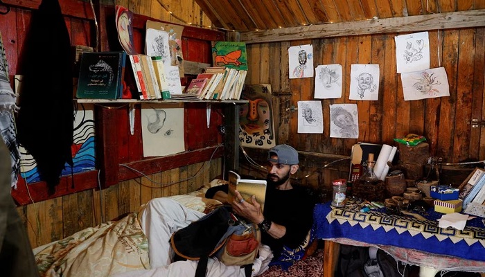 A Palestinian man, reads a book in his coffee shop in Gaza Strip January 23, 2023. — Reuters/File