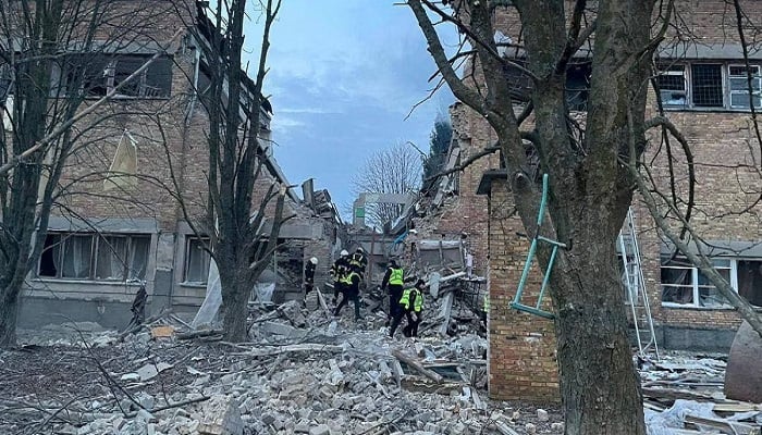 Rescue officials search through the rubble of a building that was hit by missiles after Russia launched drone attacks on cities overnight. — Reuters