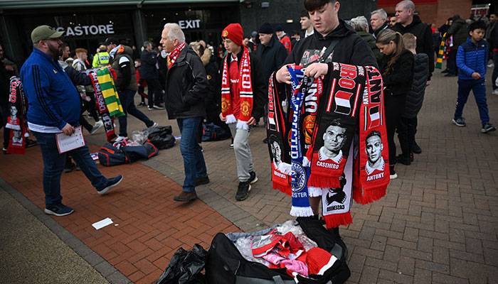 Fans arrive outside of Old Trafford stadium in Manchester north west England, ahead of the English Premier League football match between Manchester United and Leicester City, on February 19, 2023. AFP/File