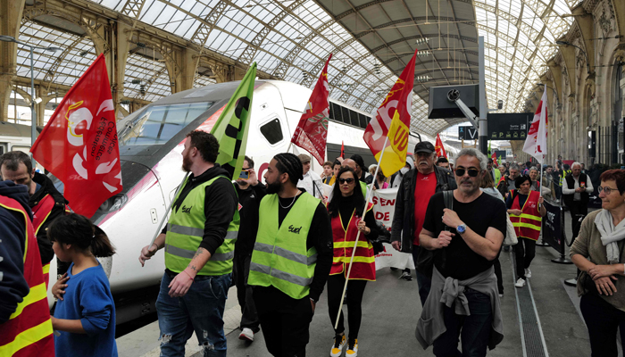 People demonstrate against the law reforming the pensions system at Nices railway station, south-eastern France, on March 22, 2023. — AFP