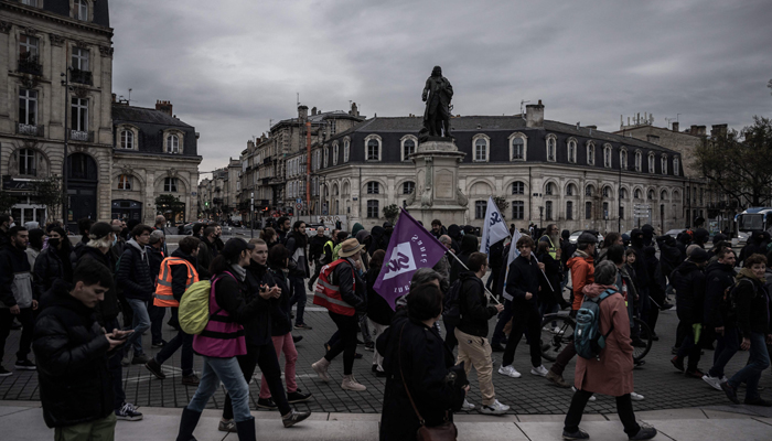 Protesters march during a demonstration, a few days after the government pushed a pensions reform through parliament without a vote, using article 49.3 of the constitution, in Bordeaux, southwestern France, on March 22, 2023. — AFP