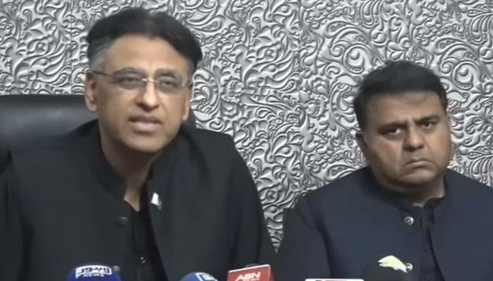 PTI Secretary General Asad Umar (left) and Senior Vice President Fawad Chaudhry address a press conference on March 23, 20223, in this still taken from a video. — Twitter/@PTIofficial