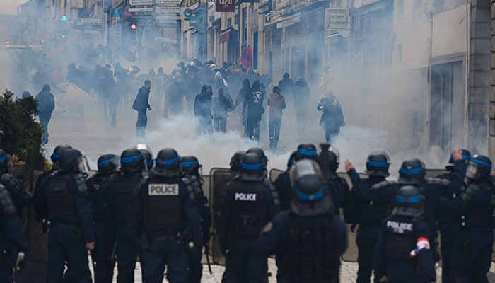 French police officers clash with protestors during a demonstration, a week after the government pushed a pensions reform through parliament without a vote, using article 49.3 of the constitution, in Nancy, eastern France on March 23, 2023.—AFP