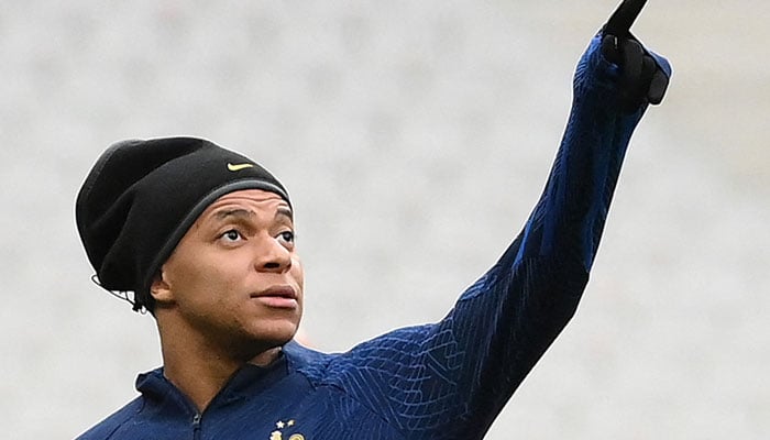 France´s forward Kylian Mbappe gestures as he arrives for a training session at the Stade de France in Saint-Denis, north of Paris on March 23, 2023, on the eve of the UEFA Euro 2024 football tournament qualifier football match against Netherlands. AFP