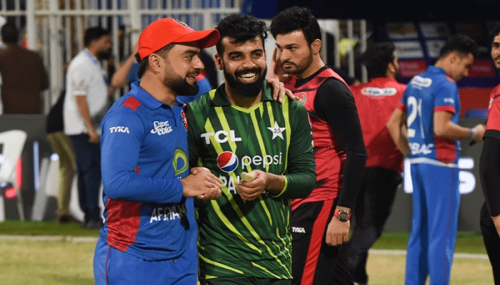 Pakistan skipper Shadab Khan and Afghanistan skipper Rashid Khan interact during the opening T20 International in Sharjah on March 24, 2023. — Twitter/@ACBofficials