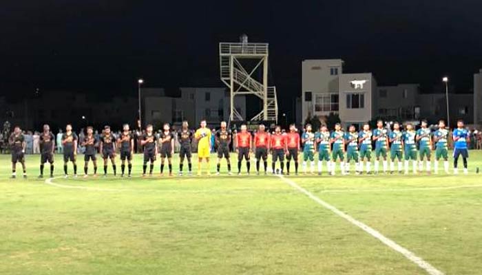 Teams stand in the field before the first match at the Naya Nazimabad Football Stadium on March 25, 2023. — Photo by author