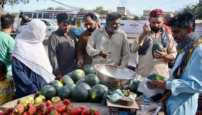 People buy fresh fruits from vendors on the first day of Ramadan on March 23, 2023. — APP