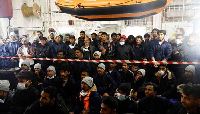 Migrants rescued by MSF on 24 March 2023 listen to an explanation of where they are onboard the Geo Barents ship. — Reuters