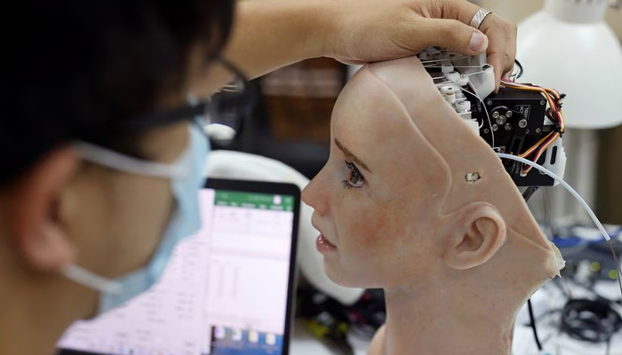An engineer adjusts the head of humanoid robot Grace, developed by Hanson Robotics and designed for the healthcare market, to interact and comfort the elderly and isolated people, especially those suffering during the coronavirus disease (COVID-19) pandemic, at the companys lab in Hong Kong, China May 4, 2021. Picture taken May 4, 2021. — Reuters/File