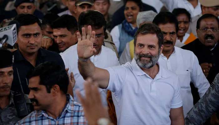 Rahul Gandhi, a senior leader of Indias Congress party, waves towards his party workers as he arrives at the New Delhi airport in Gujarat, India, March 23, 2023. — Reuters