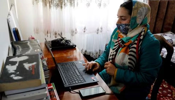 Sana, an Afghan teacher, teaches during an online class, at her house in Kabul, Afghanistan, February 28, 2023.—Reuters