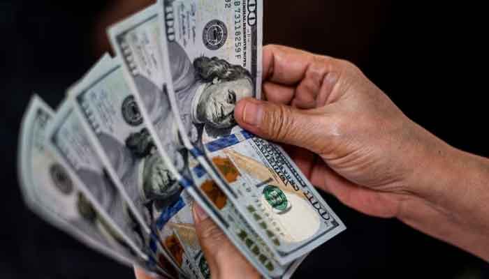 A person shows US dollars at a currency exchange store in Manila, Philippines, October 21, 2022. — Reuters