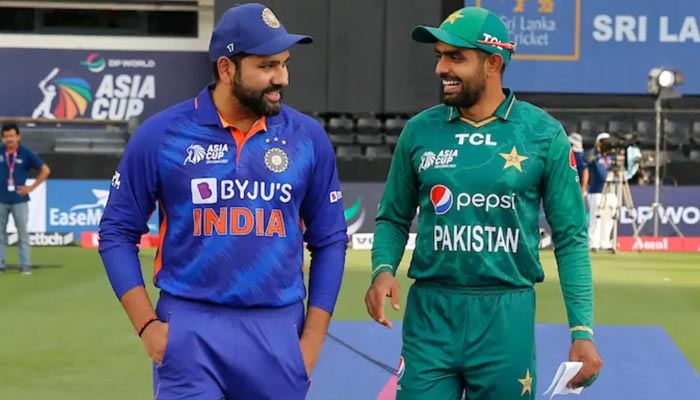 Pakistan skipper Babar Azam (L) and laugh along his Indian counterpart Rohit Sharma in this undated image. — Reuters/File