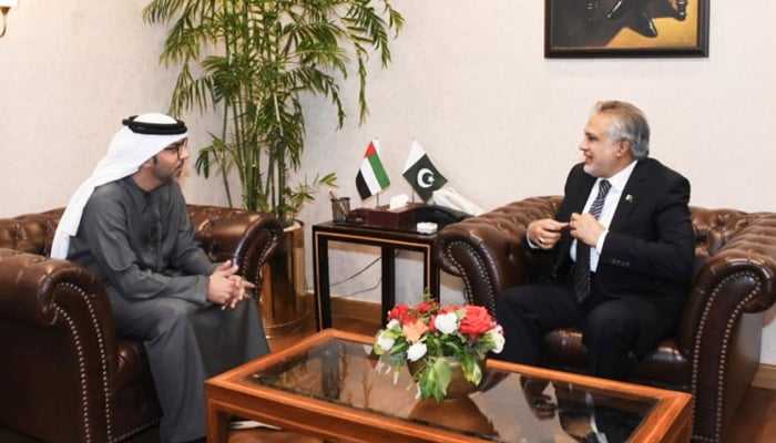Minister for Finance and Revenue Ishaq Dar (right) speaks to UAEs ambassador to Pakistan, Hamad Obaid Ibrahim Salim Al-Zaabi, in Islamabad, on March 29, 2023. — Twitter/@FinMinistryPak