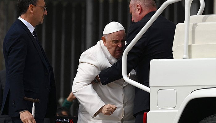 Pope Francis is helped get up the popemobile car as he leaves on March 29, 2023, at the end of the weekly general audience at St. Peter´s square in The Vatican. Pope Francis has been at the Gemelli Hospital in Rome since the afternoon of March 29, 2023, for some previously scheduled check-ups, the Holy See press director said.—AFP
