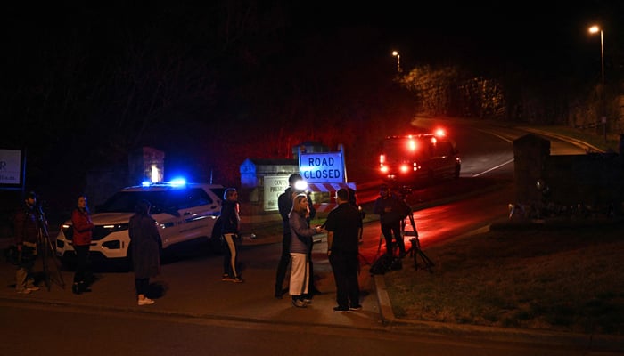 People gather outside the Covenant School building at the Covenant Presbyterian Church following a shooting, in Nashville, Tennessee, on March 27, 2023. — AFP