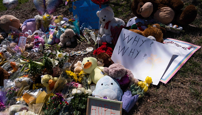 Flowers, balloons, and other items in memory of victims of a mass shooting are left at a makeshift memorial at the entrance of The Covenant School on March 29, 2023, in Nashville, Tennessee. — AFP
