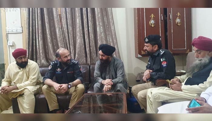 SSP Operations Haroon-ul-Rashid Khan shares his condolences with household  members of the Sikh shopkeeper Dayal Singh astatine  his residence connected  March 31, 2023. — Photo by author
