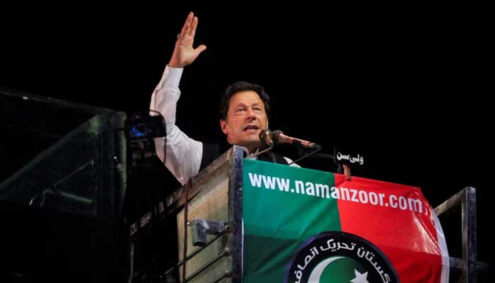 PTI chief Imran Khan gestures as he addresses supporters during a rally, in Lahore, on April 21, 2022. — Reuters