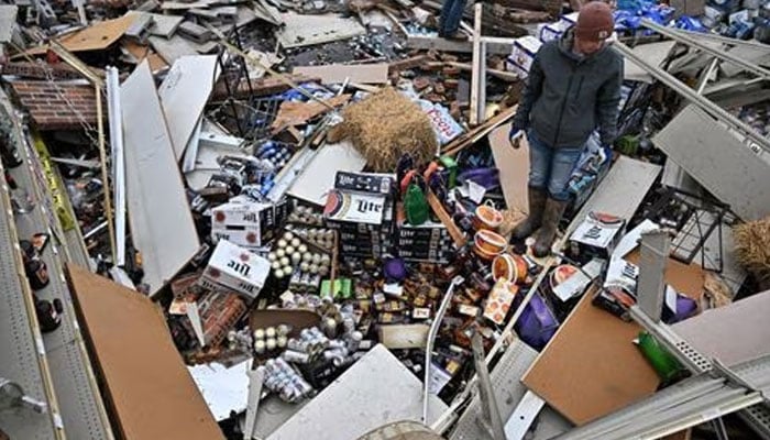 A person stands inside a destroyed convenience store the day after a tornado hit Sullivan, Indiana, US April 1, 2023. —Reuters