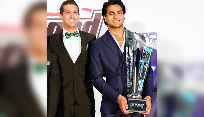 Enaam Ahmed (right) poses with his trophy. — Photo by author