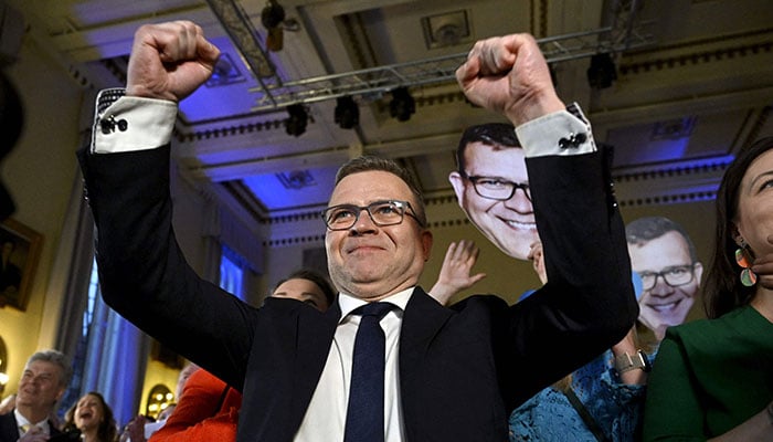 Chair of the liberal-conservative National Coalition Party Petteri Orpo reacts to the first exit poll results during the party´s parliamentary election party in Helsinki on April 2, 2023.—AFP