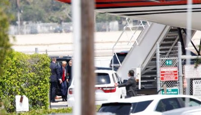 Former US President Donald Trump gets out of a vehicle near his plane, at the Palm Beach International Airport, after his indictment by a Manhattan grand jury following a probe into hush money paid to porn star Stormy Daniels, in West Palm Beach, Florida, US, April 3, 2023. —Reuters