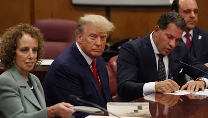 Former US President Donald Trump is accompanied by members of his legal team, Susan Necheles and Joe Tacopina, as he appears in court for an arraignment on charges stemming from his indictment by a Manhattan grand jury, April 4, 2023. —Reuters