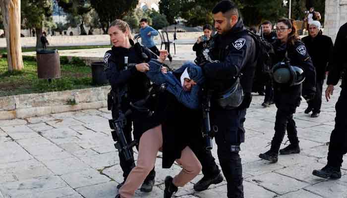 Israeli border police detain a woman at the Al-Aqsa compound, also known to Jews as the Temple Mount, while tension arises during clashes with Palestinians in Jerusalems Old City, April 5, 2023. — Reuters