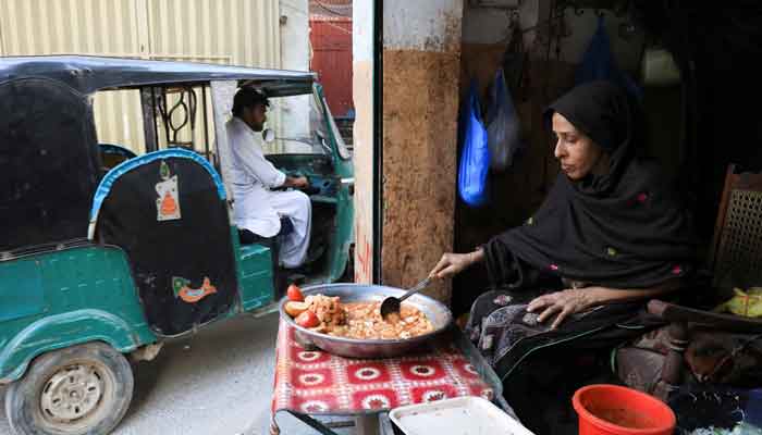 A female shopkeeper waits for customers, as she is selling taroo root curry at her shop, during the fasting month of Ramadan in Peshawar, Pakistan April 4, 2023. —Reuters