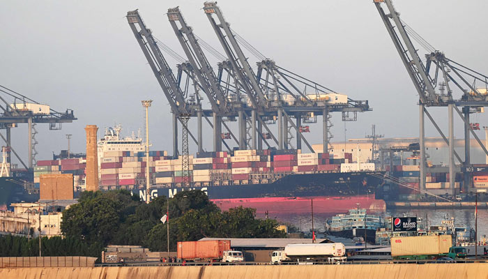 Shipping containers are seen stacked on a ship at a sea port in Karachi on April 6, 2023. — AFP