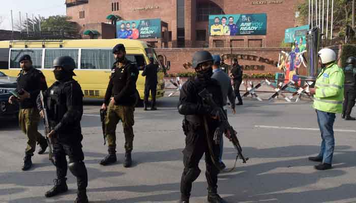 Security personnel stand guard ahead of the start of Pakistan Super League (PSL) Twenty20 cricket match, outside the Gaddafi Stadium in Lahore on Sunday. — AFP