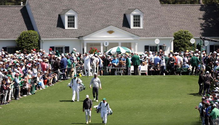 Jon Rahm of Spain and Brooks Koepka of the United States walk on the first hole during the final round of the 2023 Masters Tournament at Augusta National Golf Club on April 09, 2023, in Augusta, Georgia. — AFP